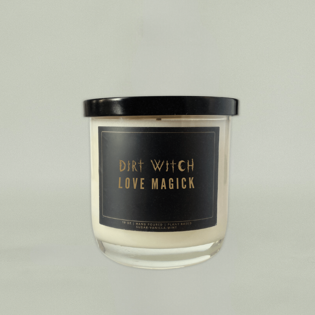 Sensual white candle with black lid.  Black label reads "Dirt Witch Love Magick". Smells like sugar, vanilla, mint.